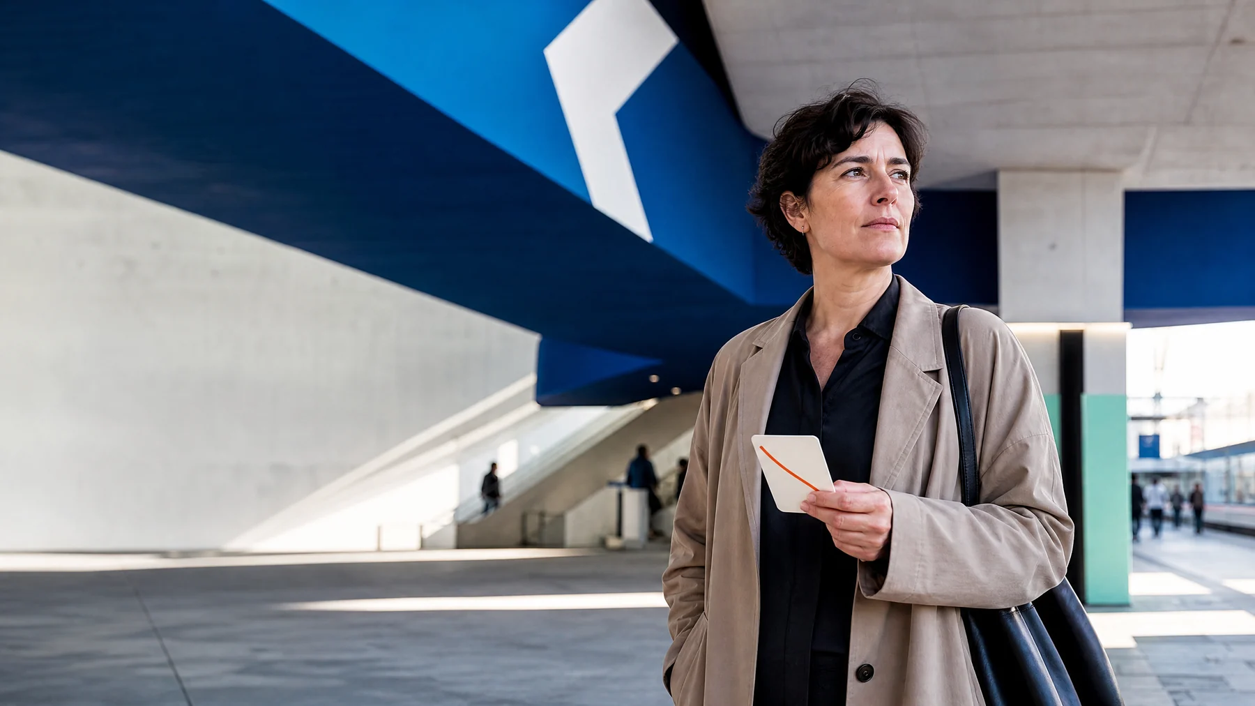 Professional holding a route card in a city transit concourse